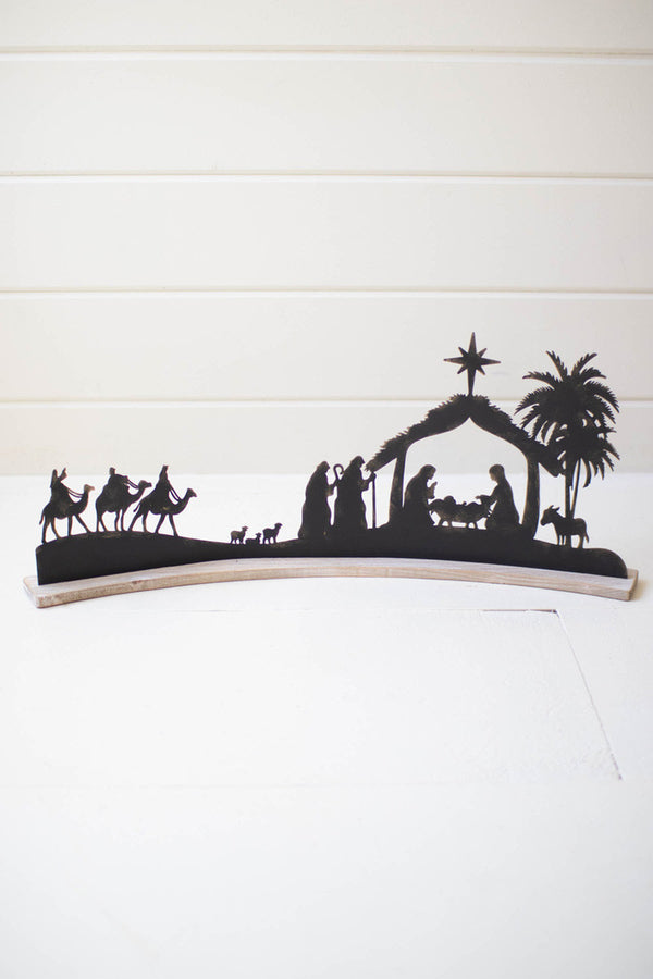 Black Metal Nativity On A Curved White Wood Base